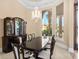 Formal dining room featuring a dark wood hutch and large window at 9237 Bellasara Circle, Myrtle Beach, SC 29579