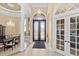 Elegant entryway with double doors, chandelier, and formal dining area at 9237 Bellasara Circle, Myrtle Beach, SC 29579