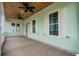 Front porch with white railings, ceiling fan, and light fixtures at 946 Crystal Water Way, Myrtle Beach, SC 29579