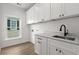 Laundry room with white cabinets and a large sink at 946 Crystal Water Way, Myrtle Beach, SC 29579