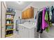 Laundry room with washer, dryer, and storage shelves at 1010 Shem Creek Circle, Myrtle Beach, SC 29588