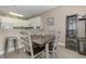 Cozy dining area with four chairs and adjacent kitchen at 112 Cypress Point Ct. # 202, Myrtle Beach, SC 29579