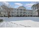 Three-story building with balconies and snowy landscape at 112 Cypress Point Ct. # 202, Myrtle Beach, SC 29579