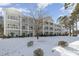 Three-story building with balconies, snow-covered lawn at 112 Cypress Point Ct. # 202, Myrtle Beach, SC 29579