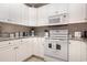 White kitchen with granite countertops and ample cabinet space at 112 Cypress Point Ct. # 202, Myrtle Beach, SC 29579