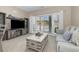 Living room with grey couch and view of balcony overlooking snow covered landscape at 112 Cypress Point Ct. # 202, Myrtle Beach, SC 29579