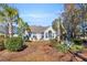 Landscaped backyard with palm trees and patio area at 116 Cobblestone Dr., Pawleys Island, SC 29585