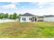 Home exterior with a large backyard and screened porch at 124 Marley Blue Dr., Little River, SC 29566