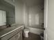 Well-lit bathroom featuring a shower-tub combo, a white toilet, and a single sink vanity at 1245 Crested Iris Way, North Myrtle Beach, SC 29582