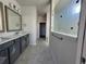 Bathroom featuring double vanity, framed mirrors, and a glass-enclosed shower at 1245 Crested Iris Way, North Myrtle Beach, SC 29582