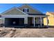 New construction home with two-car garage and front porch at 1245 Crested Iris Way, North Myrtle Beach, SC 29582