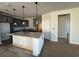 Modern kitchen featuring a central island with a light countertop and contemporary pendant lighting at 1245 Crested Iris Way, North Myrtle Beach, SC 29582