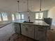 Bright kitchen with large island, stainless steel dishwasher, and modern pendant lighting at 1245 Crested Iris Way, North Myrtle Beach, SC 29582