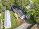 Aerial view of gray home with black roof and wooden deck in a wooded neighborhood at 1533 Sand Dollar Ln., Garden City Beach, SC 29576