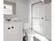 This bathroom features a bright white shower with a glass enclosure, a sink, and a toilet at 1533 Sand Dollar Ln., Garden City Beach, SC 29576