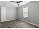 Bright bedroom with wood-look flooring, ceiling fan, and window blinds at 1533 Sand Dollar Ln., Garden City Beach, SC 29576