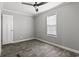This bedroom offers stylish wood-look floors, a ceiling fan, and a sunny window at 1533 Sand Dollar Ln., Garden City Beach, SC 29576