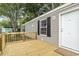 Close-up of the entryway, featuring a well-kept front door and wood-planked deck at 1533 Sand Dollar Ln., Garden City Beach, SC 29576