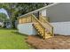 Close-up of a single-story home featuring a wooden deck with stairs and white trim at 1533 Sand Dollar Ln., Garden City Beach, SC 29576