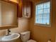 Small bathroom with single sink, toilet, and cabinet at 201 Melody Gardens Dr., Surfside Beach, SC 29575