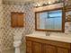 Bathroom with double vanity, shower, and floral wallpaper at 201 Melody Gardens Dr., Surfside Beach, SC 29575