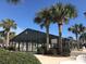 Enclosed community pool area with palm trees and seating at 201 Melody Gardens Dr., Surfside Beach, SC 29575