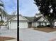 House exterior with a white garage door and a paved driveway at 201 Melody Gardens Dr., Surfside Beach, SC 29575