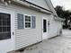 House exterior with patio, doors, and window shutters at 201 Melody Gardens Dr., Surfside Beach, SC 29575