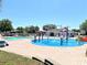 Community pool and splash pad with lounge chairs at 201 Melody Gardens Dr., Surfside Beach, SC 29575