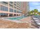 Outdoor pool with lounge chairs and patio tables at 2207 S Ocean Blvd. # 1119, Myrtle Beach, SC 29577