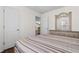 Bedroom with striped bedding and dresser; view of kitchen at 244 Mckendree Ln., Myrtle Beach, SC 29579