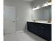 Modern bathroom featuring double vanity with gold hardware, quartz countertops and neutral tile flooring at 25 Northbrook Dr, Murrells Inlet, SC 29576