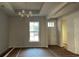 Bright dining room with a chandelier and large window, showcasing natural light at 25 Northbrook Dr, Murrells Inlet, SC 29576