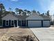 Charming new construction home with a three car garage, blue siding, and white trim at 25 Northbrook Dr, Murrells Inlet, SC 29576