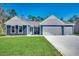 Charming home with blue siding, white trim, and a spacious three-car garage at 25 Northbrook Dr, Murrells Inlet, SC 29576