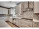Well-lit kitchen features white cabinets, geometric backsplash, stainless steel appliances, and quartz countertops at 25 Northbrook Dr, Murrells Inlet, SC 29576