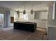 Modern kitchen with white cabinets, geometric backsplash, and large island at 25 Northbrook Dr, Murrells Inlet, SC 29576