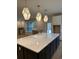 Large kitchen island with navy cabinets, white countertop, geometric pendants and ample space for cooking and entertaining at 25 Northbrook Dr, Murrells Inlet, SC 29576