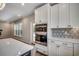 Modern kitchen displays stainless steel double ovens and a geometric tile backsplash at 25 Northbrook Dr, Murrells Inlet, SC 29576