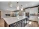 Open-concept kitchen features a large island, stainless steel appliances, and seamlessly connects to the living area at 25 Northbrook Dr, Murrells Inlet, SC 29576