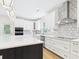 Stylish kitchen with white cabinets, an island, and designer backsplash at 25 Northbrook Dr, Murrells Inlet, SC 29576