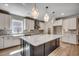 Kitchen with island and farmhouse sink features stainless steel appliances, geometric backsplash, and pendant lighting at 25 Northbrook Dr, Murrells Inlet, SC 29576