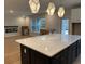 Modern kitchen featuring a large island with a white countertop and contemporary pendant lighting at 25 Northbrook Dr, Murrells Inlet, SC 29576