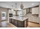 Open kitchen showcases a large island, pendant lights, stainless steel appliances, and geometric backsplash at 25 Northbrook Dr, Murrells Inlet, SC 29576