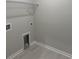 Neutral laundry room featuring tiled floors and wire rack shelving at 25 Northbrook Dr, Murrells Inlet, SC 29576