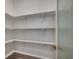 Walk-in pantry with ample white shelving provides abundant storage space at 25 Northbrook Dr, Murrells Inlet, SC 29576
