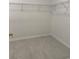 Empty walk-in closet area with wire shelving and neutral tile flooring at 25 Northbrook Dr, Murrells Inlet, SC 29576