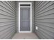 Gray front door with white trim and small window at 275 Columbus St., Conway, SC 29526