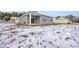 Gray house exterior with covered patio and snowy yard at 275 Columbus St., Conway, SC 29526