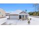 Tan house with white garage door, snow covered yard at 281 Columbus St., Conway, SC 29526